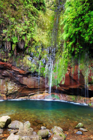 Beautiful landscape view of the 25 Fontes falls, a cascade waterfall at the end of a levada hike on the island of Madeiraの写真素材