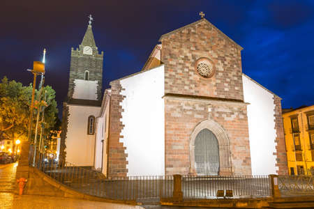 Beautiful cityscape of the Cathedral of Our Lady of the Assumption (Portuguese, Catedral de Nossa Senhora da Assuncao) in Se, Funchal, Madeira, Portugal, at night in the blue hourの写真素材