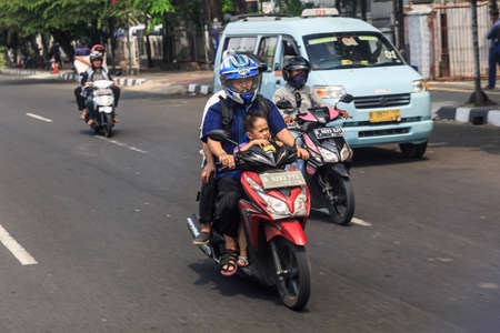 Typical view of people commuting with scooter in traffic in the streets of Jakarta, Indonesia, on August 2, 2015のeditorial素材