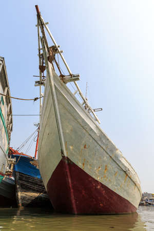 Beautiful view of traditional Pinisi vessels of the Lamba (or Lambo) type in the old Sunda Kelapa harbor or Jakarta, Indonesiaの写真素材