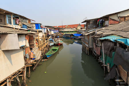Beautiful view of generic homes at the waterfront in the old Sunda Kelapa harbor area in Jakarta, Indonesiaの写真素材