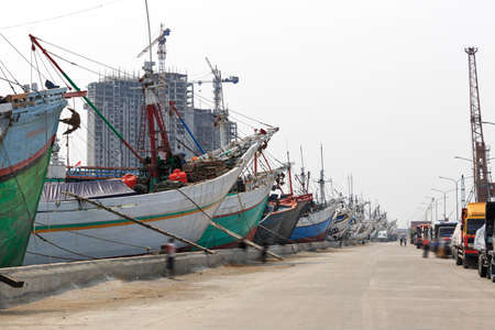 Beautiful view of traditional Pinisi vessels of the Lamba (or Lambo) type in the old Sunda Kelapa harbor or Jakarta, Indonesiaの写真素材
