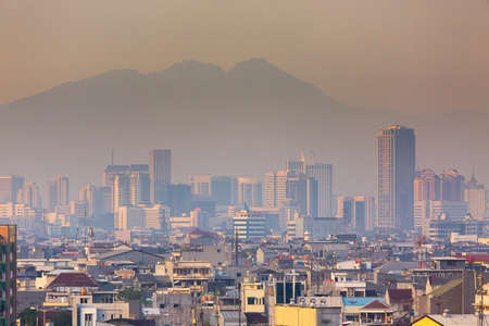 Beautiful aerial cityscape view of the skyline of Jakarta (seen from Kota tua aka old town or Batavia), Indonesia, at sunriseの写真素材