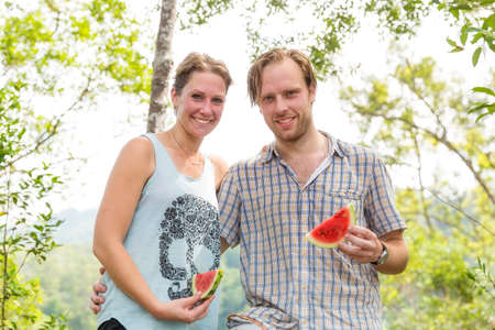 Beautiful tourists posing during an orangutan ecotourism jungle hike in Gunung Leuser National Park, Bukit Lawang, Sumatra, Indonesiaの写真素材