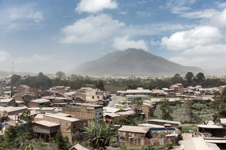 Beautiful cityscape of Berastagi, Sumatra, with a volcanic ash covered landscape by volcano Mount Sinabungの写真素材