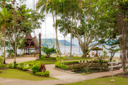 Beautiful view of the tropical tourist destination Tuktuk, on the island Samosir in Lake Toba, Sumatra, Indonesiaの写真素材
