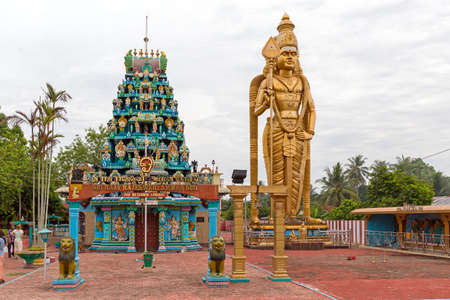 Beautiful view of a large golden Kartikeya (aka Murugan, Skanda, Kumara, Subrahmanya) statue at the Sri raja rajesweri amman koil Hindu temple in Sumatra, Indonesiaのeditorial素材