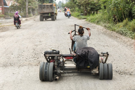 Indonesian daredevil on a home-made trike on the streets of Sumatra, Indonesia, on August 6, 2015