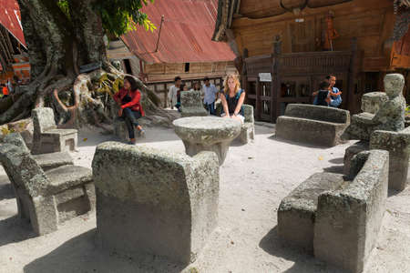 Tourists visit popular attraction Huta Siallagan in Ambarita, on the island Samosir in Lake Toba, Sumatra, Indonesia, on August 9, 2015のeditorial素材