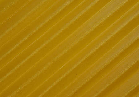 background italian yellow lasagna close up with visible textureの写真素材