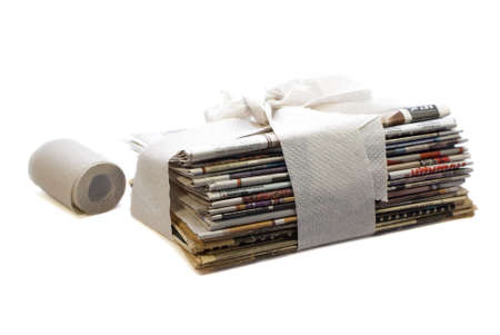 stack of newspapers wrapped in toilet paper conceptの写真素材