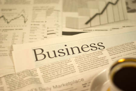 heading newspaper, business pages with a cup of coffeeの写真素材