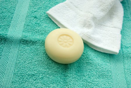 soap and two towels green and white