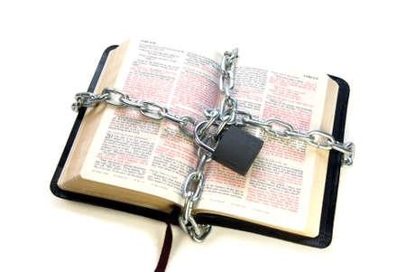 open bible chained isolated over white backgroundの写真素材