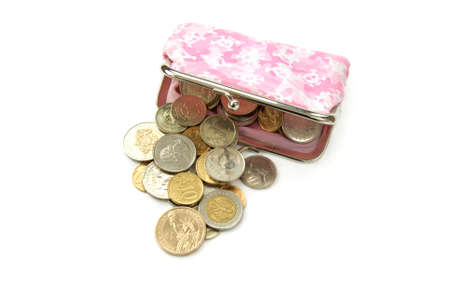 assorted world coins with purse isolated over whiteの写真素材