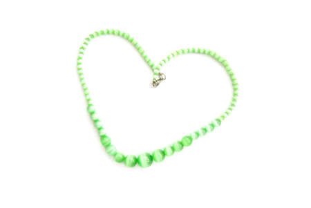 chrysoberyl necklace folded in the form of heart isolated over whiteの写真素材