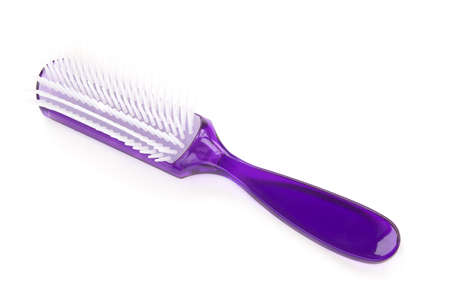 purple closeup hairbrush isolated over white backgroundの写真素材