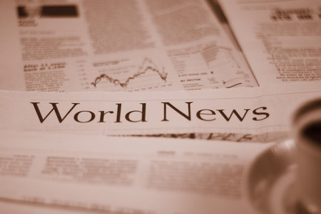 newspaper world news page with cup of cofee concept