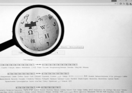 MONTREAL, CANADA - FEBRUARY, 2016: Wikipedia homepage on the computer screen under magnifying glass....