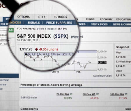 MONTREAL, CANADA - FEBRUARY, 2016 - S&P 500 stock market index on web page under magnifying glass.のeditorial素材