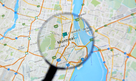 MONTREAL, CANADA - FEBRUARY, 2016 - Montreal on Google maps app under magnifying glass.