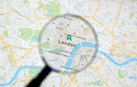 MONTREAL, CANADA - FEBRUARY, 2016 - London on Google maps app under magnifying glass.のeditorial素材