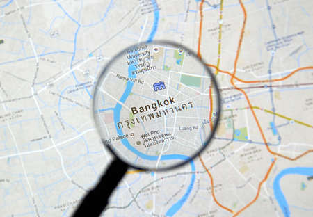 MONTREAL, CANADA - FEBRUARY, 2016 - Bangkok on Google maps app under magnifying glass.のeditorial素材