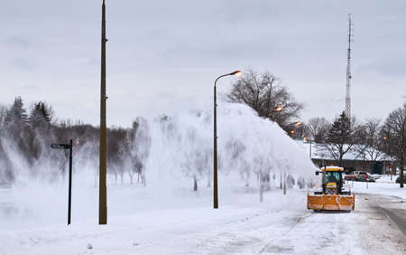 MONTREAL, CANADA - FEBRUARY, 2016 - Snowblower track cleaning a road near Montr Royal park, Montreal. MONTREAL, CANADA - FEBRUARY, 2016 - Snowblower track cleaning a road near Montr Royal park, Montreal.