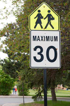Maximum 30 speed limit sign with yellow 'pedestrians' sign.の写真素材