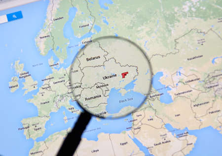 MONTREAL, CANADA - MARCH 3, 2016 - Ukraine on Google maps under magnifying glass. Ukraine is Western Europe country well known because of war on Donbass region.のeditorial素材
