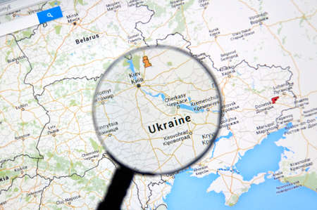 MONTREAL, CANADA - MARCH 3, 2016 - Ukraine on Google maps under magnifying glass. Ukraine is Western Europe country well known because of war on Donbass region.のeditorial素材