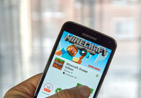 MONTREAL, CANADA - MARCH, 2016 -  Minecraft mobile game on screen of Samsung S5 in a hand. Minecraft is a game where gamer digs mine and builds craft.のeditorial素材