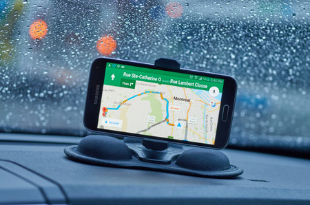 MONTREAL, CANADA - MARCH 15, 2016 - GPS application Google Maps on Samsung S5 im a car over wet...