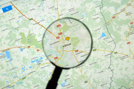 MONTREAL, CANADA - MARCH 17, 2016 -  Vilnius Lithuania on Google Maps app under magnifying glass.のeditorial素材