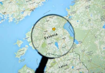 MONTREAL, CANADA - MARCH 17, 2016 -  Estonia on Google Maps app under magnifying glass.のeditorial素材