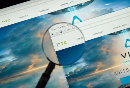 MONTREAL, CANADA - MARCH 25, 2016 - HTC internet page under magnifying glass. HTC Corporation is a Taiwanese multinational manufacturer of smartphones and tablets.のeditorial素材
