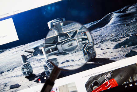 MONTREAL, CANADA - JUNE 4, 2016 : Photo of Audi lunar quattro oh web page on a laptop screen through a magnifying glass.のeditorial素材