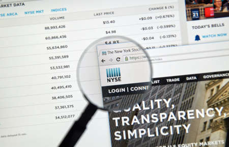 MONTREAL, CANADA - JUNE 24, 2016 : NYSE web page under magnifying glass. The New York Stock Exchange, abbreviated as NYSE and nicknamed 'The Big Board' is an American stock exchangeのeditorial素材