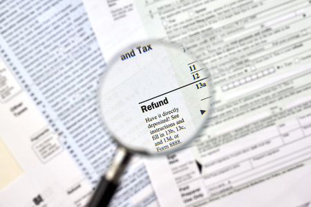 'Refund' under magnifying glass on 1040 U.S individual income tax return form