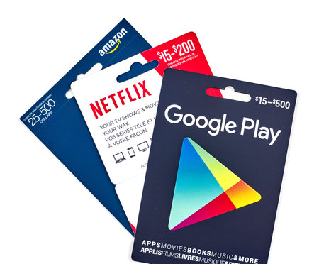 MONTREAL, CANADA - MARCH 10, 2017 : Google Play, Netflix and Amazon popular giftcards. The cards are...