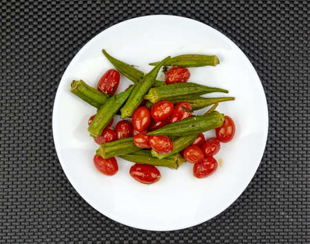 Okra cooked with red tomatoes and garlicの写真素材
