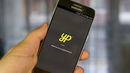 MONTREAL, CANADA - JULY 14, 2017 - Yellow Pages mobile application. Yellow pages refers to a telephone directory of businesses, organized by categoryのeditorial素材