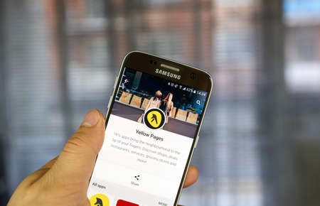 MONTREAL, CANADA - JULY 14, 2017 - Yellow Pages mobile application. Yellow pages refers to a telephone directory of businesses, organized by categoryのeditorial素材