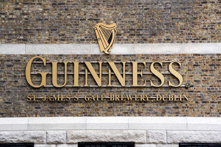 DUBLIN, IRELAND - AUGUST 3, 2017 : Guinness logo on its Storehouse in Dublin. Guinness Storehouse is a tourist attraction at St. James's Gate Brewery in Dublin, Ireland.のeditorial素材