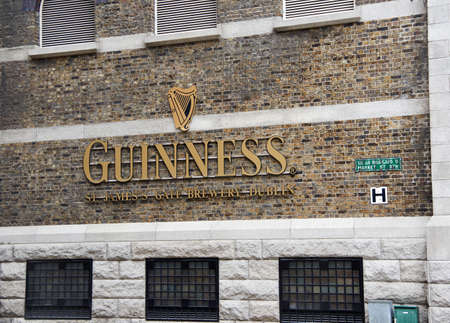 DUBLIN, IRELAND - AUGUST 3, 2017 : Guinness logo on its Storehouse in Dublin. Guinness Storehouse is a tourist attraction at St. James's Gate Brewery in Dublin, Ireland.のeditorial素材