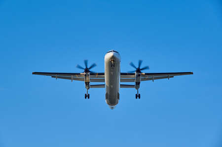 Landing propeller airplane on a blue sky backgroundのeditorial素材
