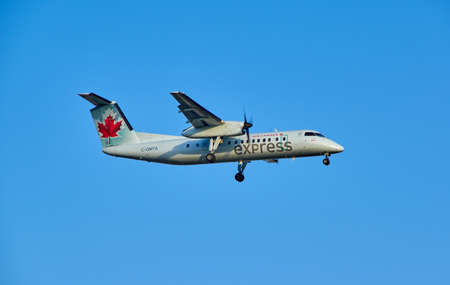MONTREAL, CANADA - AUGUST 28, 2017 : C-GMTA - Bombardier Dash 8 Q300 landing plane. Air Canada Express is a brand name under which four regional airlines operate feeder flights for Air Canada.のeditorial素材