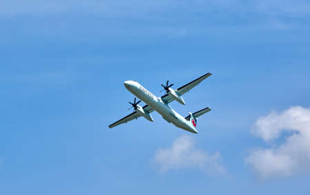 MONTREAL, CANADA - AUGUST 28, 2017 : Air Canada Express landing plane. Air Canada Express is a brand name under which four regional airlines operate feeder flights for Air Canada.のeditorial素材