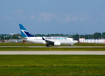 MONTREAL, CANADA - AUGUST 28, 2017 : WestJet C-FWSF Boeing 737 taxiing. WestJet Airlines Ltd. is a...