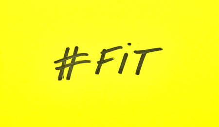 Popular hashtag fit written on a yellow paperの写真素材